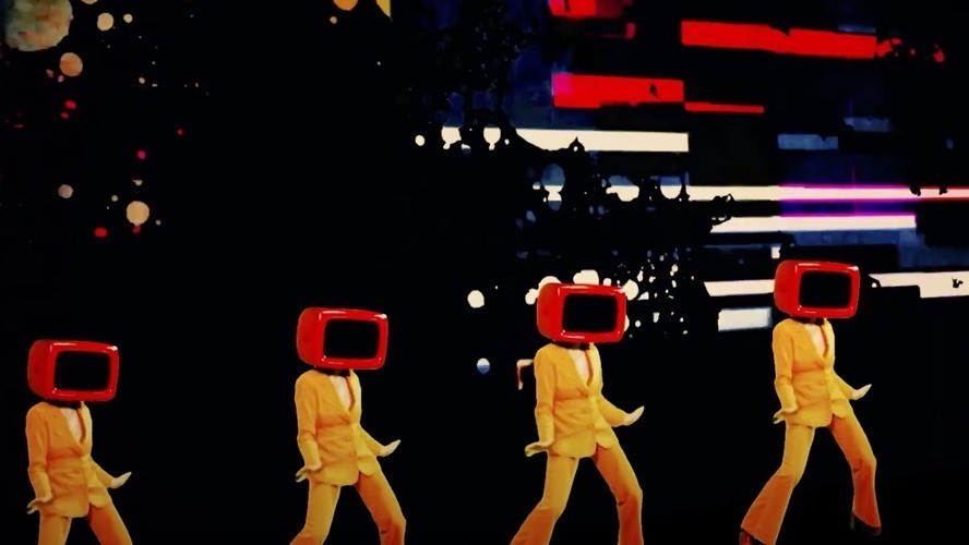 A vibrant stage scene featuring performers in colourful costumes during The Bowie Show.
