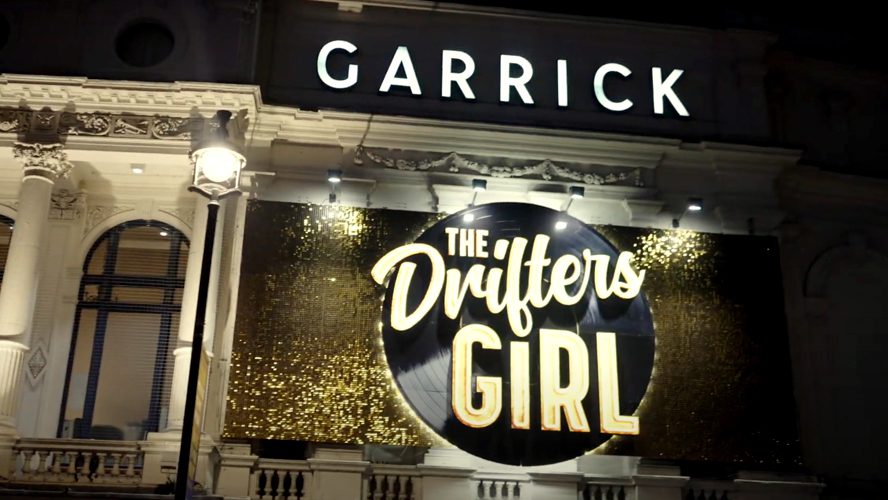 Garrick Theatre exterior featuring a large marquee and vibrant signage for The Drifters Girl.