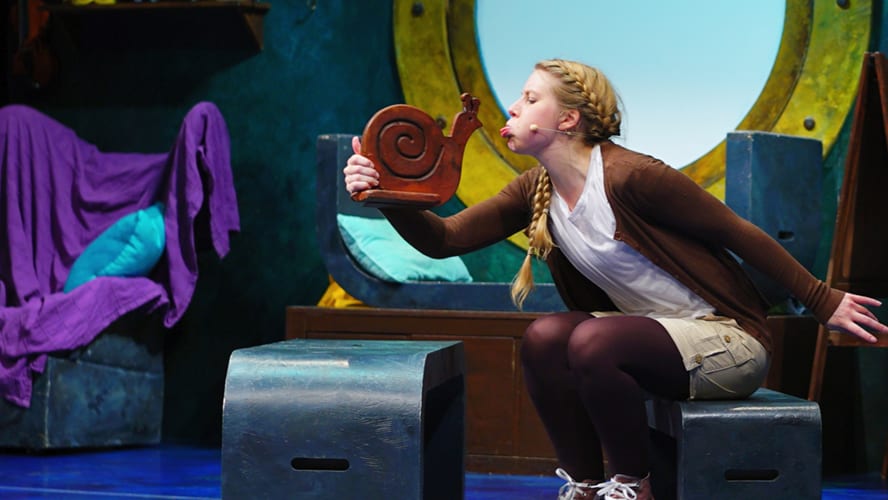 A snail and a whale swimming together in a vibrant ocean scene.