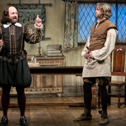 Cast members of "The Upstart Crow" pose together on stage at the Apollo Theatre.