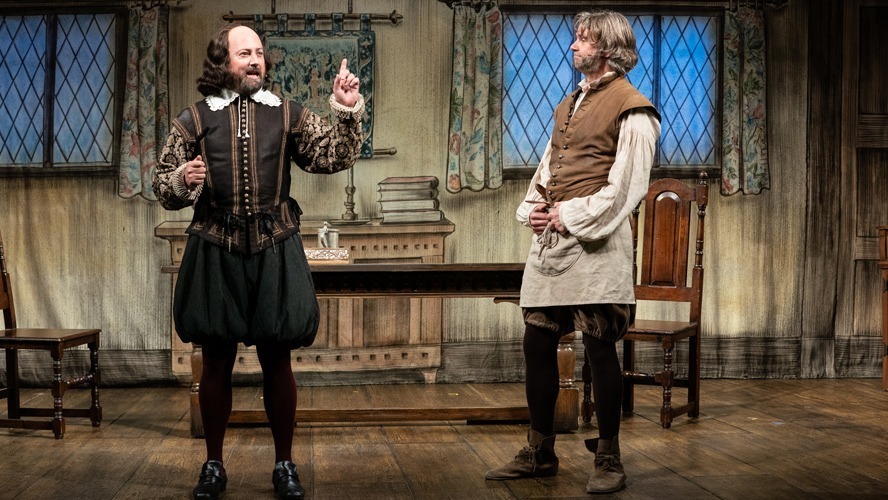 Cast members of "The Upstart Crow" pose together on stage at the Apollo Theatre.