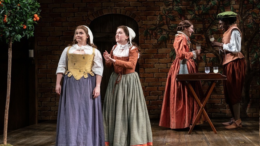 Cast members of The Upstart Crow performing on stage at the Apollo Theatre, dressed in period costumes.