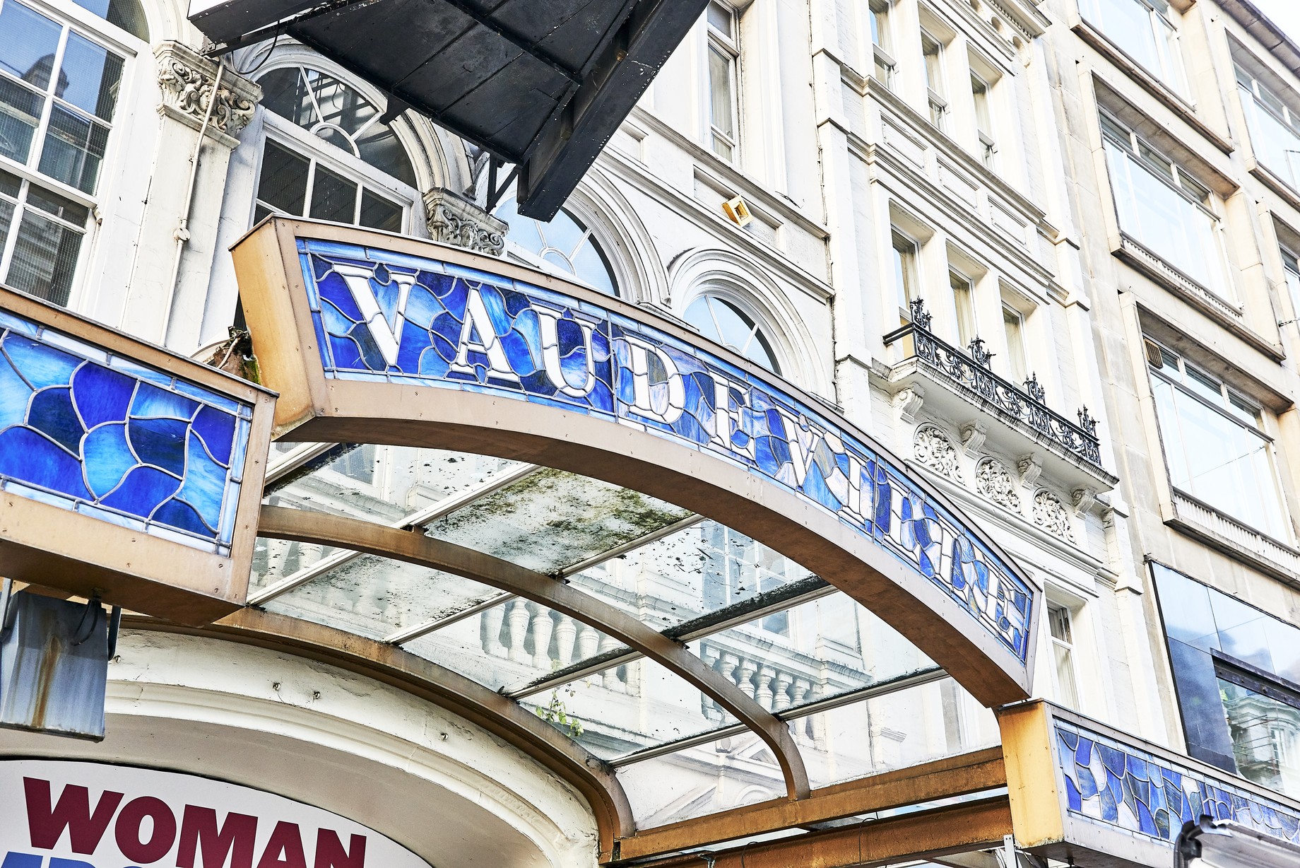 Exterior view of the Vaudeville Theatre, showcasing its ornate architecture and illuminated marquee.