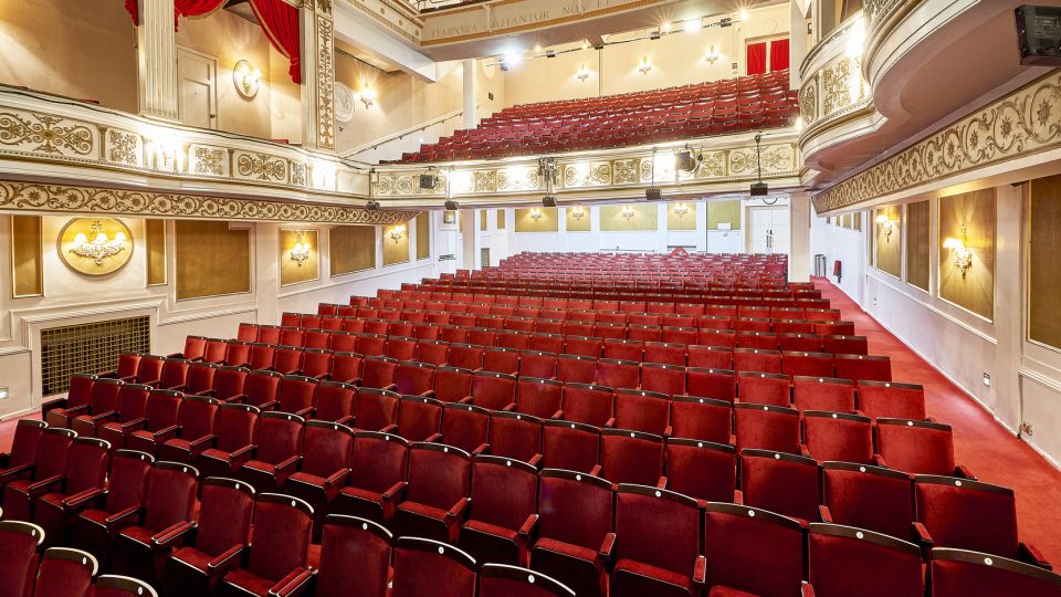 Exterior view of the Vaudeville Theatre, featuring ornate architecture and a prominent marquee.