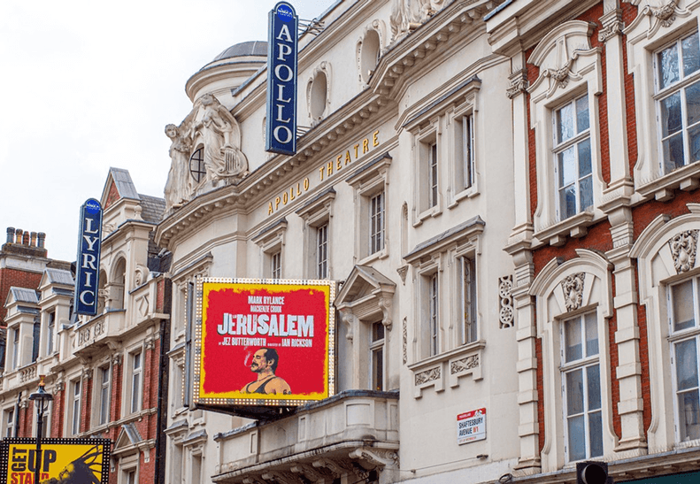 Exterior view of Apollo Theatre, showcasing its iconic marquee and ornate architectural details.