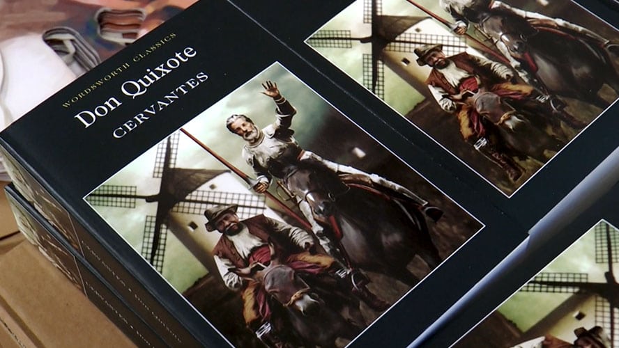 Cover of "Don Quixote" novel featuring a knight on horseback against a vibrant landscape.