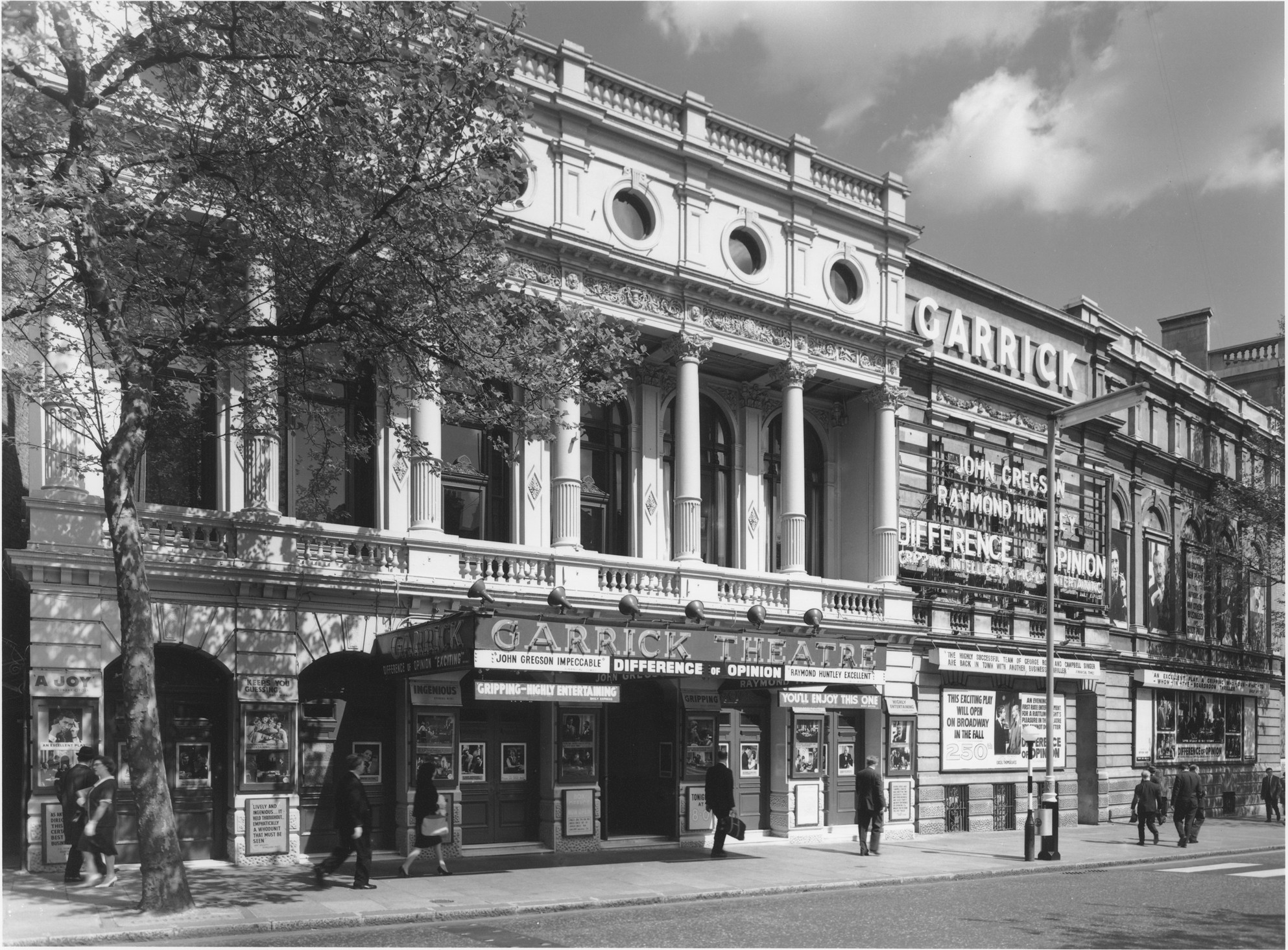 Garrick Theatre exterior featuring a classic façade and illuminated marquee at night.