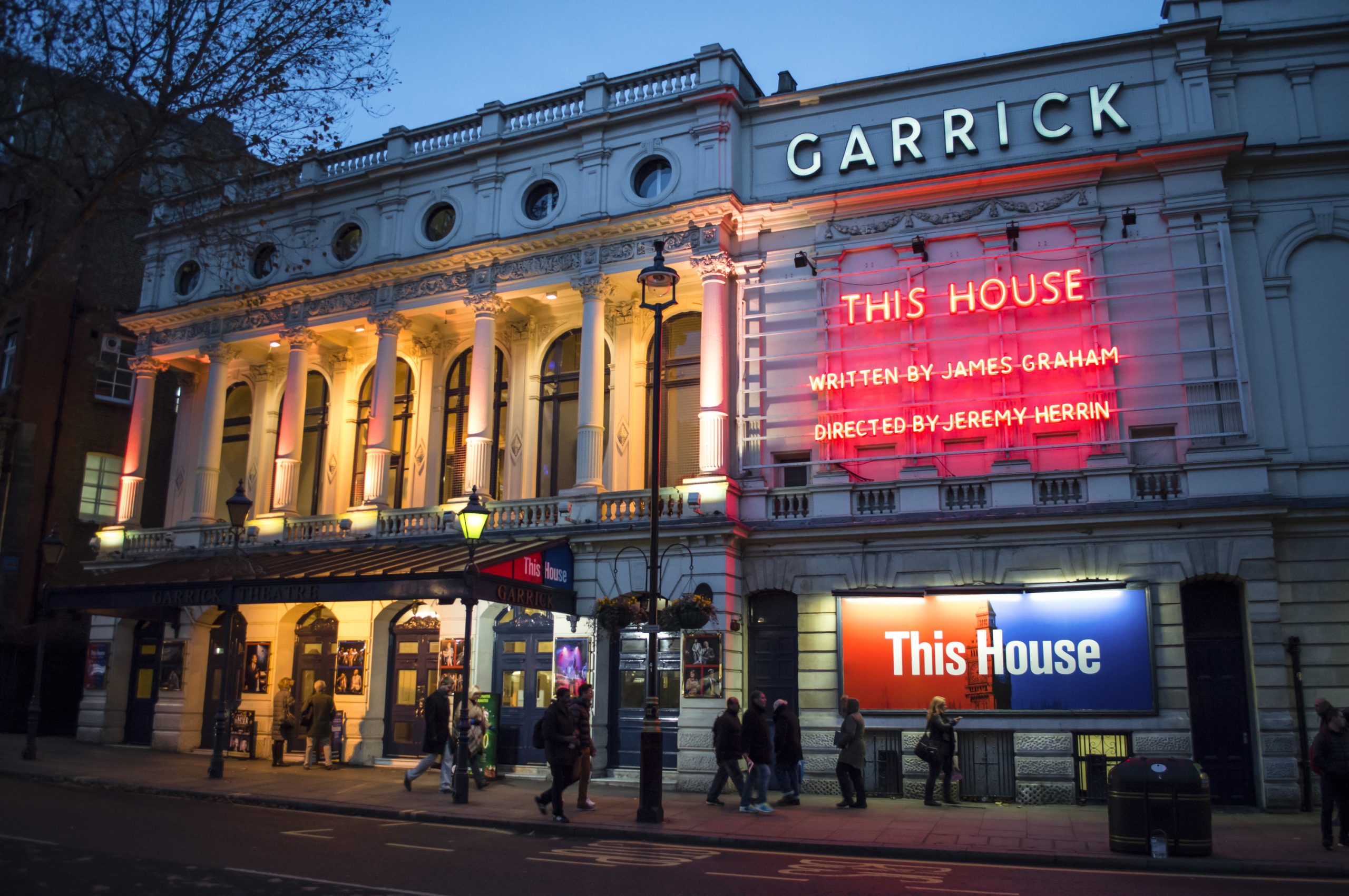 Garrick Theatre exterior featuring a classic façade and illuminated marquee at night.