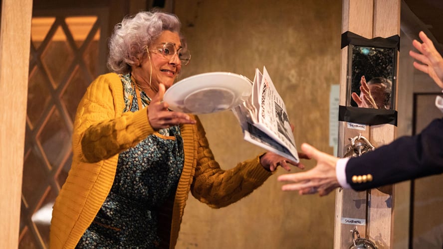 A stage scene from "Noises Off" at the Lyric Hammersmith Theatre, featuring actors in costume.