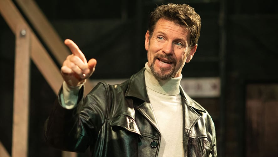 A stage scene from "Noises Off" at Lyric Hammersmith Theatre, featuring actors in dynamic poses.