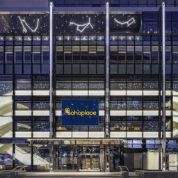 Sohoplace building exterior featuring modern architecture with large glass windows and a sleek design.