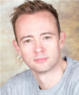 Headshot of Richard Dempsey, featuring a smiling man with short dark hair and a blue shirt.
