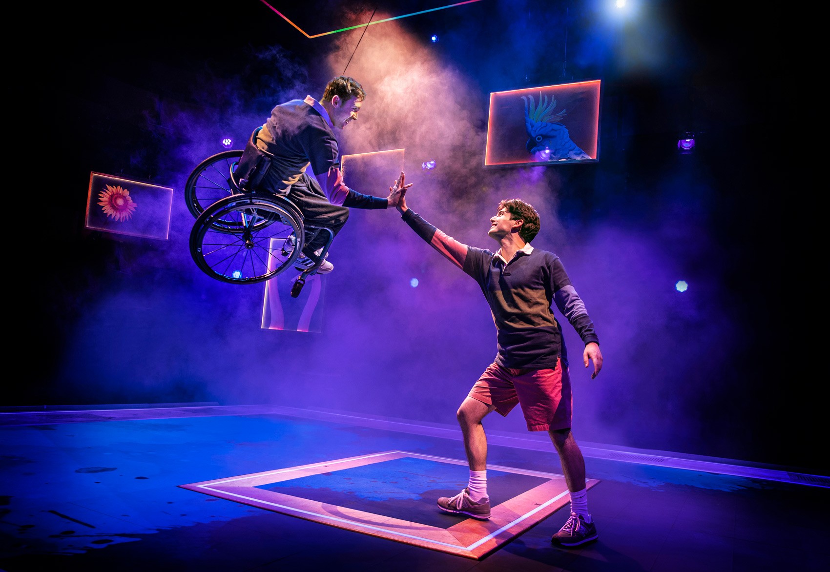 A vibrant stage set with colourful props and lighting, showcasing a dynamic theatrical performance.