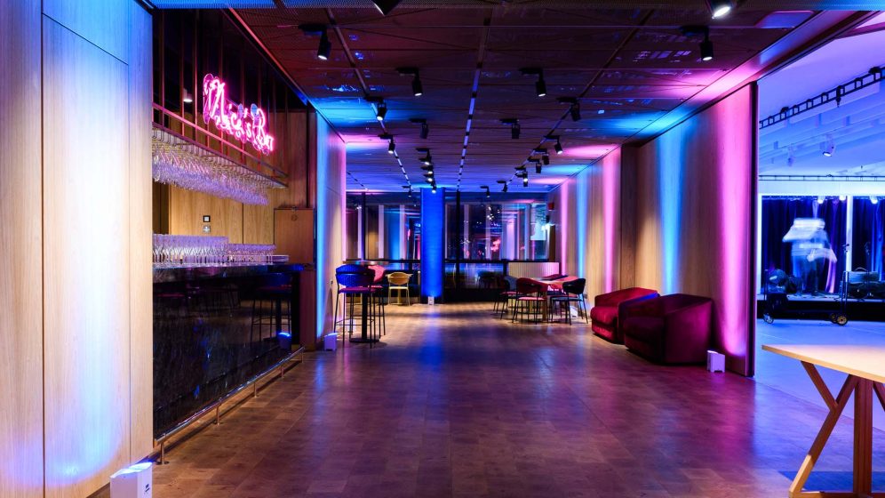 A vibrant event space with modern seating, decorative lighting, and a welcoming atmosphere.