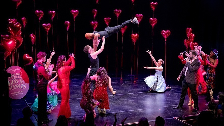 A vibrant theatre stage with a spotlight illuminating a grand piano and musical notes in the background.
