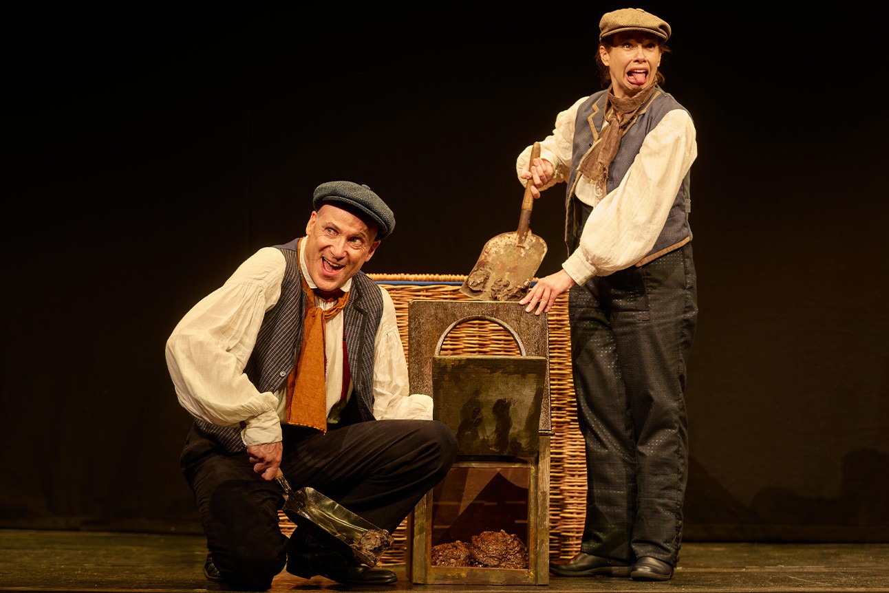 A vibrant scene from Horrible Histories: Barmy Britain, featuring characters in historical costumes and props.