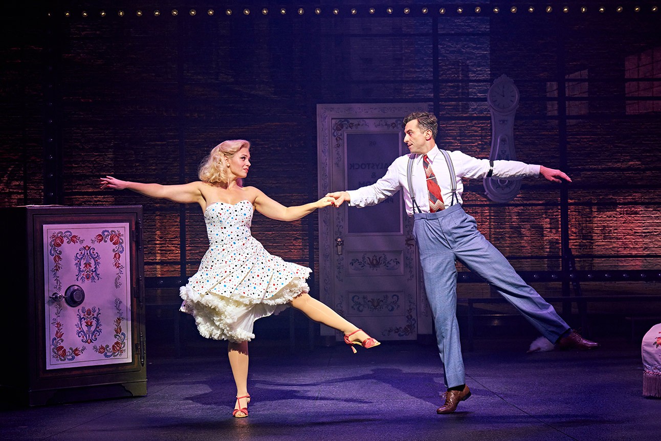 Joanna Woodward as Ulla and Marc Antolin as Leo Bloom, staged performance, vibrant costumes.