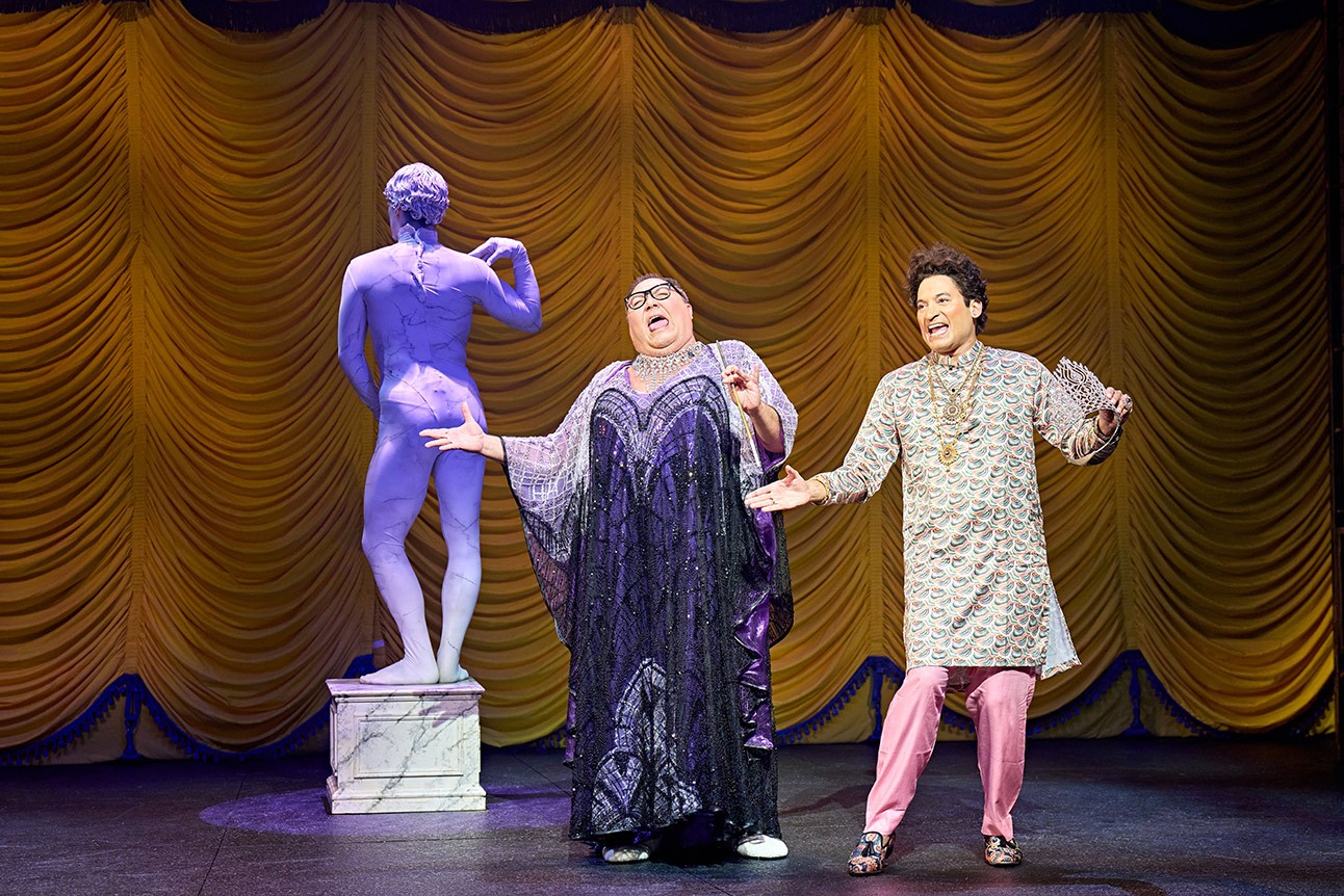 Trevor Ashley as Roger DeBris and Raj Ghatak as Carmen Ghia, in theatrical costumes.
