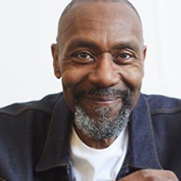 Lenny, a smiling man with short hair, poses against a neutral background.