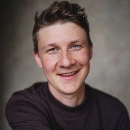 Robin, a character from The Gruffalo's Child, smiling against a soft, blurred background.
