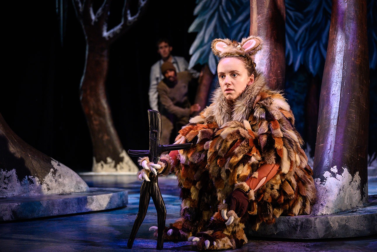 The Gruffalo's Child stands in a snowy forest, surrounded by trees and soft snowflakes.