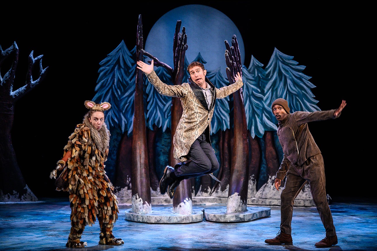 The Gruffalo's Child standing in a snowy forest, surrounded by tall trees and soft snowflakes.