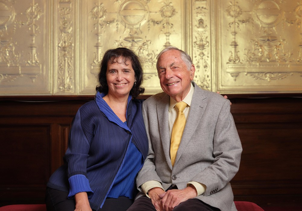 Nica Burns and Max Weitzenhoffer smiling together at an event, dressed in formal attire.