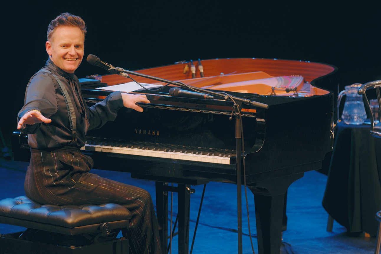 Liza Pulman and Joe Stilgoe performing on stage, with vibrant lighting and an enthusiastic audience.