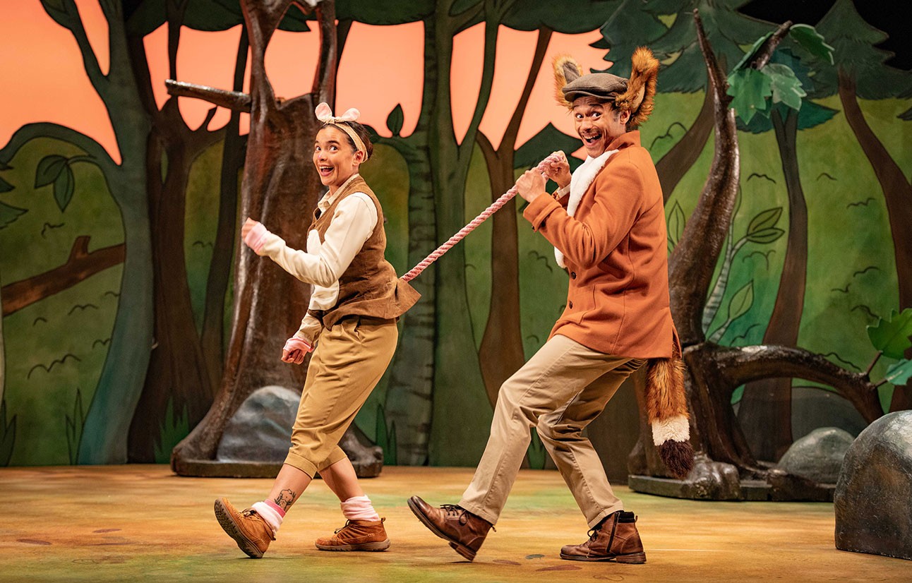 Two actors in brown costumes perform on stage with forest-themed backdrop for The Gruffalo play.