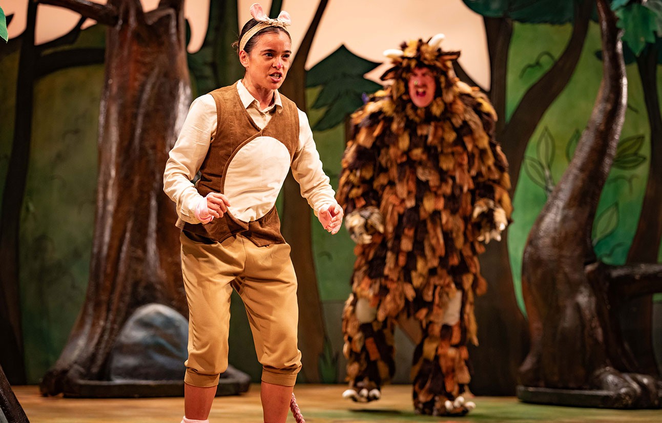 Two actors in The Gruffalo costumes perform on stage, one in brown shorts, the other in a furry creature suit.