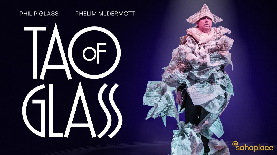 Performer in elaborate paper costume on stage, with "Tao of Glass" and "Phelim McDermott" text visible.